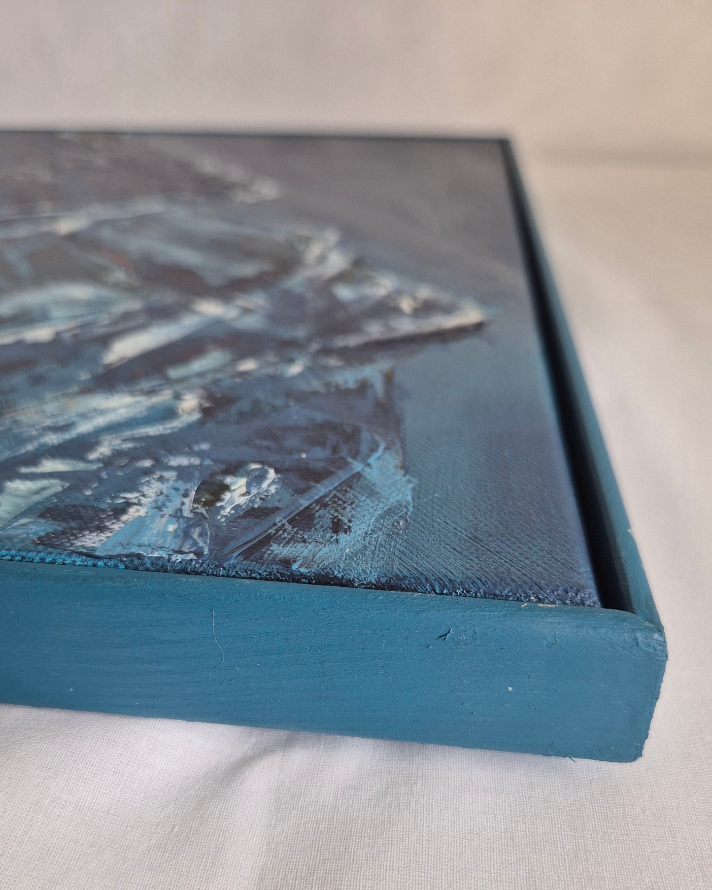 Canvas print with a blue border on a light gray background